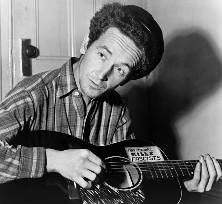 Folksinger Woody Guthrie with his famous Gibson Guitar